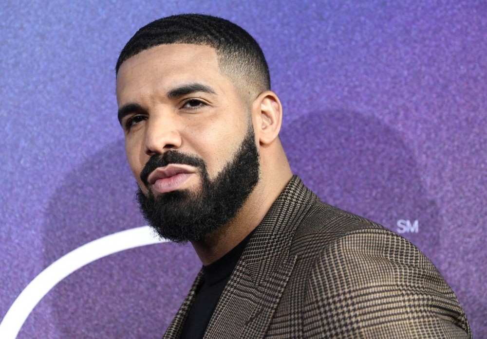 Drake Pops Champagne & Cash To Celebrate Billboard Milestone