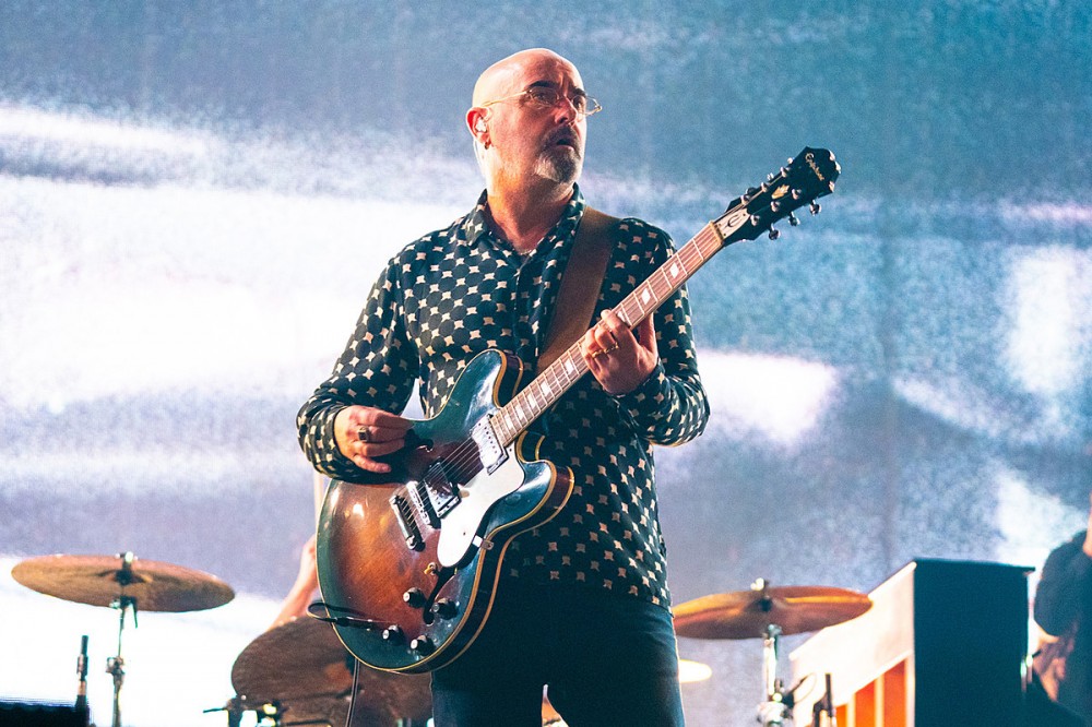 Oasis + Liam Gallagher Guitarist Paul ‘Bonehead’ Arthurs Reveals His Cancer Is ‘Gone’